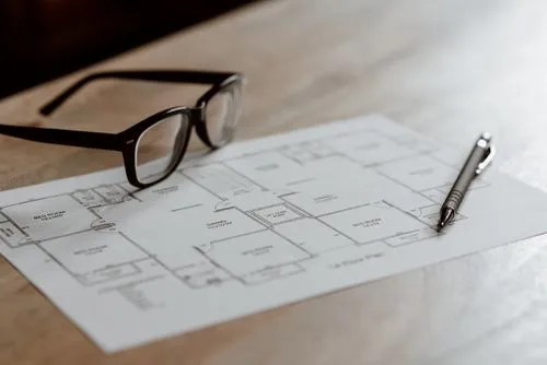 Close Up of Desk With Glasses and List